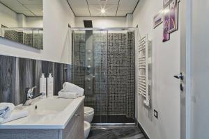 a bathroom with a shower with a sink and a toilet at Sunset Apartment above the sea by Wonderful Italy in Bogliasco