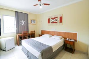 En eller flere senge i et værelse på Charme Hotel Guarujá Frente Mar