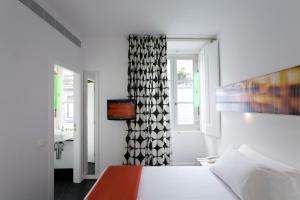 Cama o camas de una habitación en Hotel Gat Rossio
