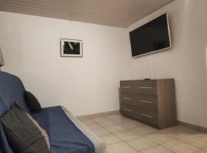 a bedroom with a bed and a tv on the wall at Casa Blouberg in Gordevio