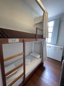 Кровать или кровати в номере Casarão Hostel