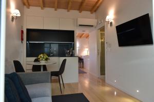 a living room with a kitchen and a table with chairs at The Castle House in Lamego