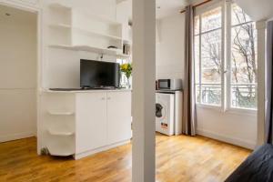 萬塞訥的住宿－PARIS Vincennes authentique -`ღ，白色的公寓设有一间厨房和一个客厅。