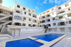 a large apartment building with a large swimming pool at Playa Flamenca Splendid apartment on the beach in Alicante