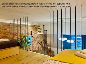 a bedroom with a bed and a brick wall at Retro Apartment Old Town in Wrocław
