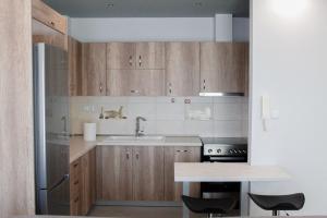 a kitchen with wooden cabinets and a sink at Apartment Ori in Drama