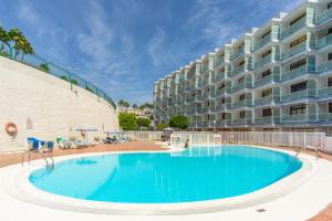 a large swimming pool in front of a building at Modern & Elegant Loft in Playa del Ingles