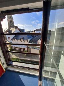 a view of a city from a window at Le Mondes in Le Pouliguen