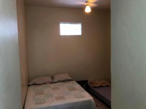 a small bedroom with a bed and a window at Apto perto das praias do Flamengo e do Botafogo in Rio de Janeiro