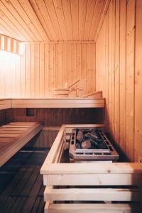 an inside of a sauna with a stove in it at Sosnowy Taras in Koszele