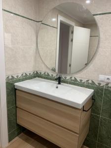 a bathroom with a sink and a mirror at UIM Mediterraneo Buenavista Wifi in Puerto de Sagunto +14 photos