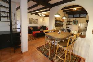 
a kitchen with a table, chairs, and a refrigerator at Casa Mia Suites in San Miguel de Allende
