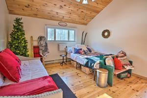 a bedroom with a christmas tree and a bed and a couch at Pet-Friendly Gilford Home by Gunstock Ski Mountain in Gilford