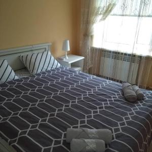 a large bed in a bedroom with a window at Apartments comfortablе in Chernivtsi +10 photos