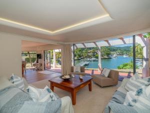 a living room with a view of the water at Amalfi - Pauanui Holiday Home in Pauanui