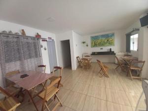 a dining room with tables and chairs in a room at HOTEL ASSIS in Assis