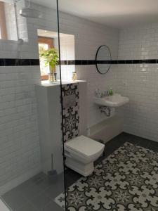 a bathroom with a toilet and a sink at L'ECURIE du Château in Lebétain +31 photos