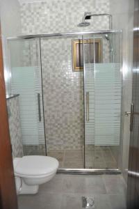 a bathroom with a shower and a toilet at Amazing one Bedroom Apartment in Amman Elwebdah 4 in Amman +23 photos