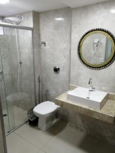 a bathroom with a toilet and a sink and a shower at CALDAS NOVAS - GO - Apartamento Parque das Aguas Quentes bloco 1 - em frente Clube Privê in Caldas Novas