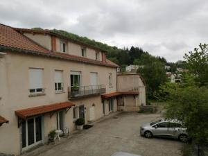 a car parked in a parking lot next to a building at RESIDENCE ROKIA - Au fil de l*eau in Royat