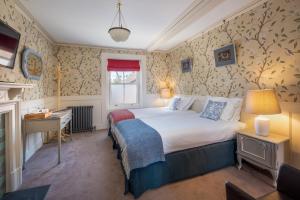 a bedroom with a large bed and a large window at One Holyrood Hotel & Cafe in Newport