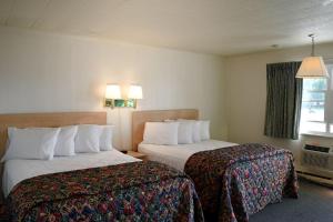 a hotel room with two beds and a window at Birchwood inn in Chincoteague