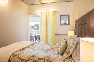 a bedroom with a large bed with a large window at 90 San Luis Street Unit A in Avila Beach