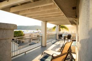 a balcony with chairs and a view of the beach at 90 San Luis Street Unit C in Avila Beach