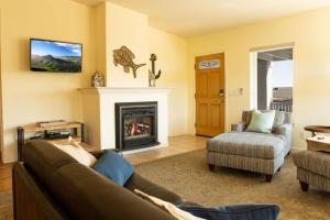 a living room with a couch and a fireplace at 90 San Luis Street Unit C in Avila Beach