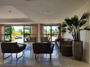 a lobby with chairs and a potted plant at Paraíso Guarajuba in Guarajuba