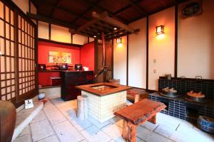 a room with a stove and a table in it at Kominkanoyado Tarumizu in Tarumizu