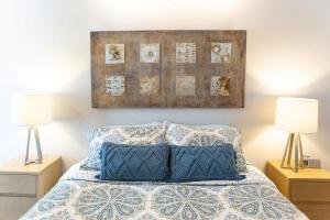 a bedroom with a bed with two night stands and two lamps at 90 San Luis Street Unit B in Avila Beach