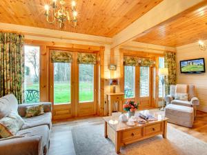 a living room with a couch and a coffee table at Apple Tree Lodge in Swarland