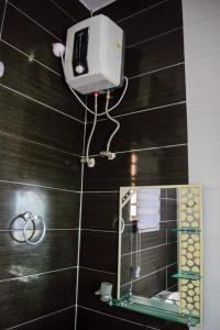 a camera on the wall of a bathroom with a mirror at Ocean Park Hotel,Lekki phase 1 in Lekki
