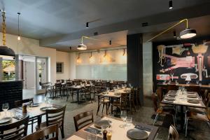 a restaurant with tables and chairs in a room at Peppers Gallery Hotel in Canberra