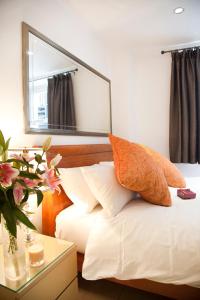 a bedroom with a bed with a mirror on the wall at City Inn Russell Square in London