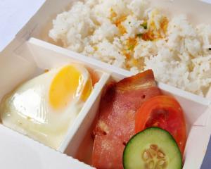 a styrofoam box with rice and a egg and a piece of meat at RedDoorz @ P Florentino Street Sampaloc Manila in Manila