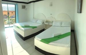 Giường trong phòng chung tại The Waterfront Beach Resort +70 ảnh