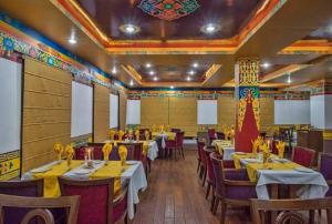 a restaurant with tables and chairs in a room at The Sera Courtyard in Leh