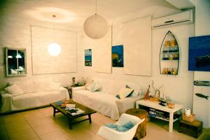 a living room with a couch and a table at Riverland Turtle Beach Villa-1min walk to beach in Protaras +91 photos
