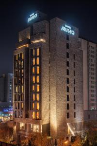 a large building with two signs on top of it at Hotel Museo Cheongju in Cheongju