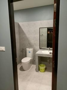 a bathroom with a toilet and a sink at น้ำเค็มอินน์ Namkhem Inn in Phangnga