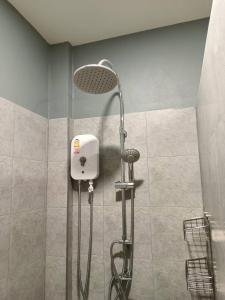 La salle de bains est pourvue d'une douche avec un pommeau de douche. dans l'établissement น้ำเค็มอินน์ Namkhem Inn, à Phangnga