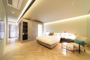 מיטה או מיטות בחדר ב-Hotel Museo Cheongju
