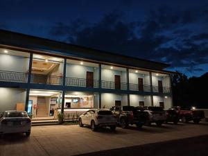 a building with cars parked outside of it at night at น้ำเค็มอินน์ Namkhem Inn in Phangnga