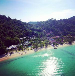 an aerial view of a beach with houses and trees at Thanya Beach Resort - SHA Plus in Ko Ngai