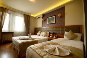Postel nebo postele na pokoji v ubytování Anzac Hotel