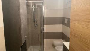 a bathroom with a shower and a toilet at La Maison in Mondragone +12 photos