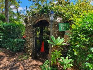 an entrance to a stone building with a street sign at Tamborine Mountain Bed and Breakfast in Mount Tamborine