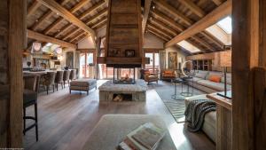 a living room with a fireplace in a house at La Ferme de Juliette in Le Grand-Bornand